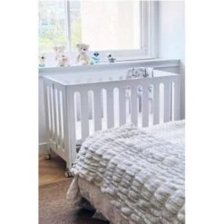 Coverplay Caden Wood Folding Crib Designed For Small Spaces In White -Home Furnishing Store 334279 LifestyleImage Lg